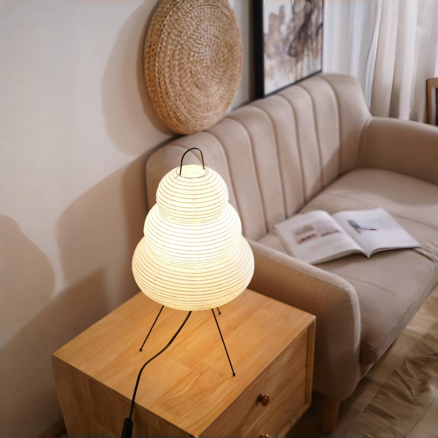 Table lamp on a wooden side table with a beige sofa and decorative items in the background