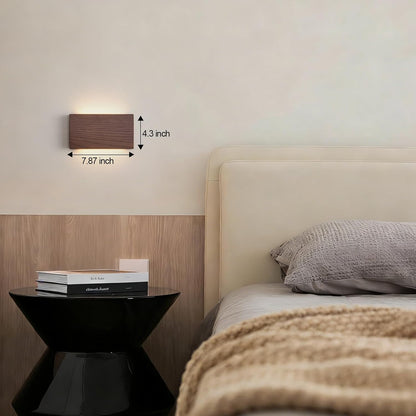 Wall-mounted lamp with dimensions displayed above a bed in a bedroom setting.