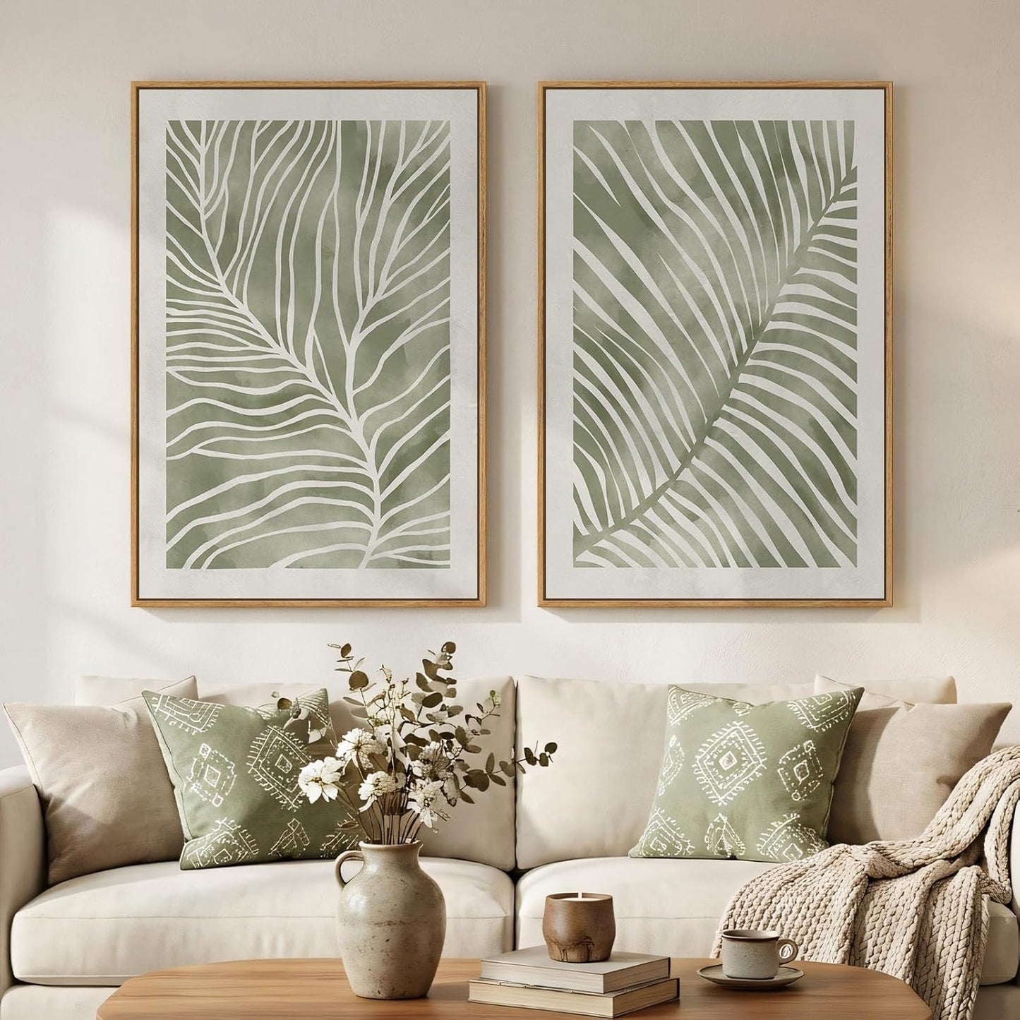 Living room with beige sofa, decorative pillows, and wall art featuring leaf patterns.
