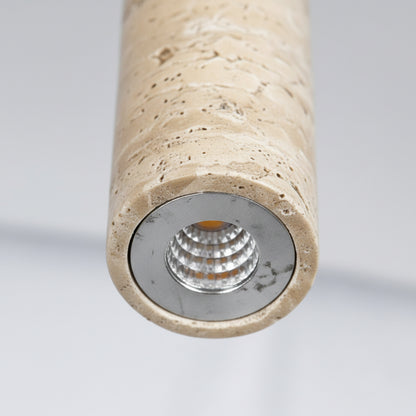 A modern pendant light with a stone-textured cylindrical lamp body hanging in a styled living room. The lower section contains three detail panels labeled 'US standard ceiling plate,' 'Stone lamp body,' and 'LED light source,' showing the ceiling mount, lamp rod, and lamp base.