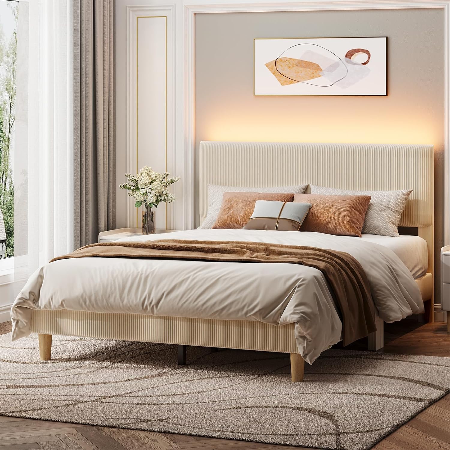 Neatly made bed with beige bedding and pillows in a bedroom setting.
