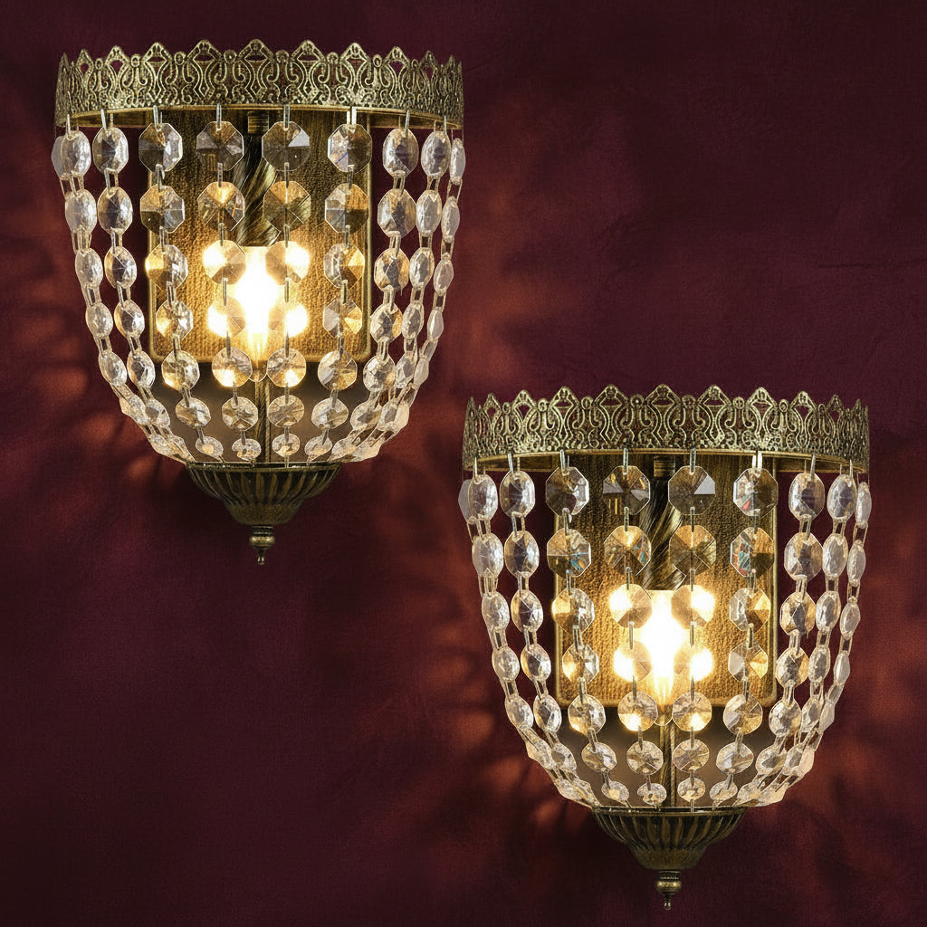 Two ornate wall sconces with crystal details on a light background.