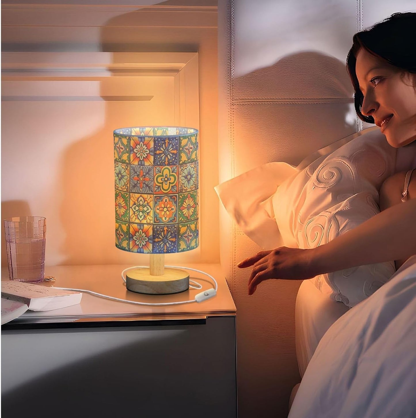 Woman in bed with a colorful lamp on the nightstand