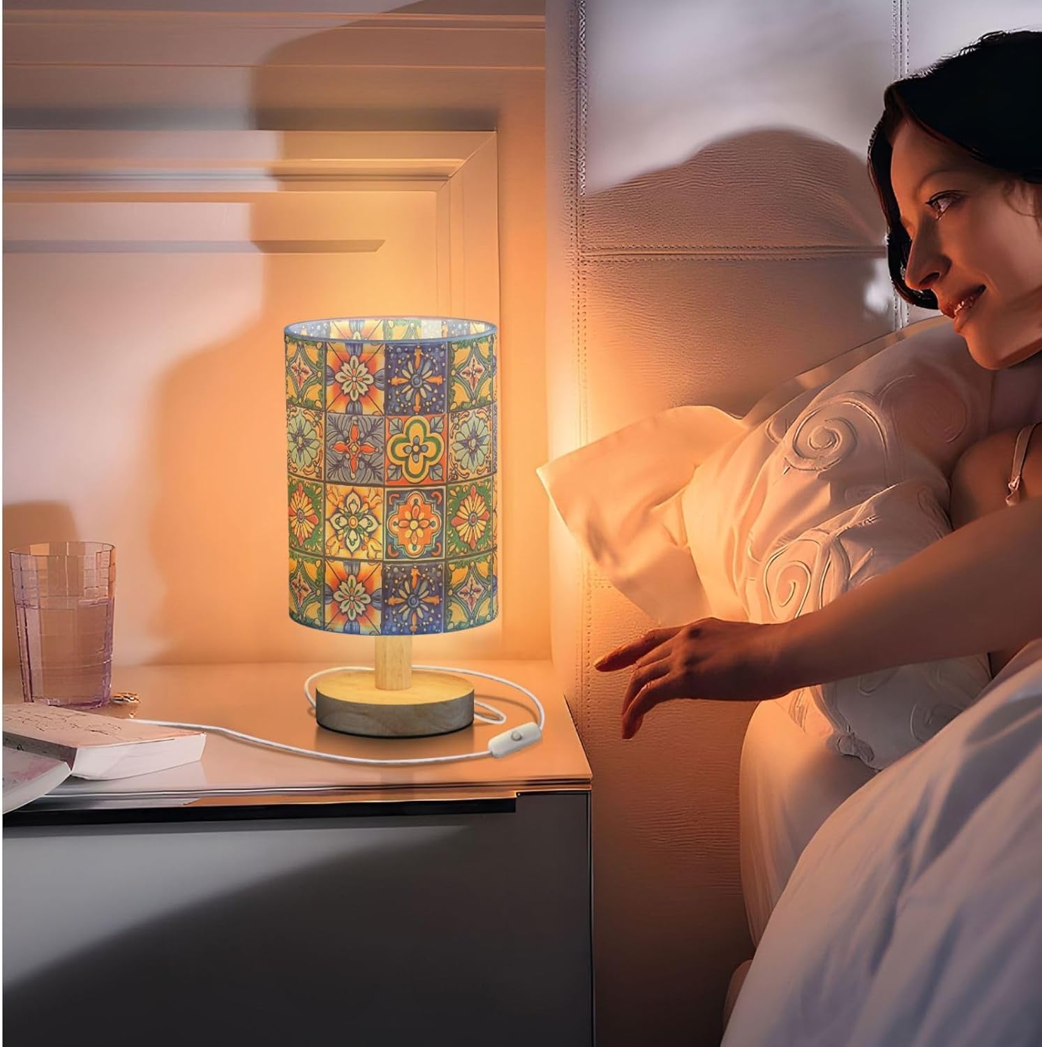Woman in bed with a colorful lamp on the nightstand