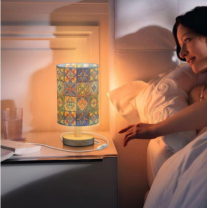 Woman in bed with a colorful lamp on the nightstand