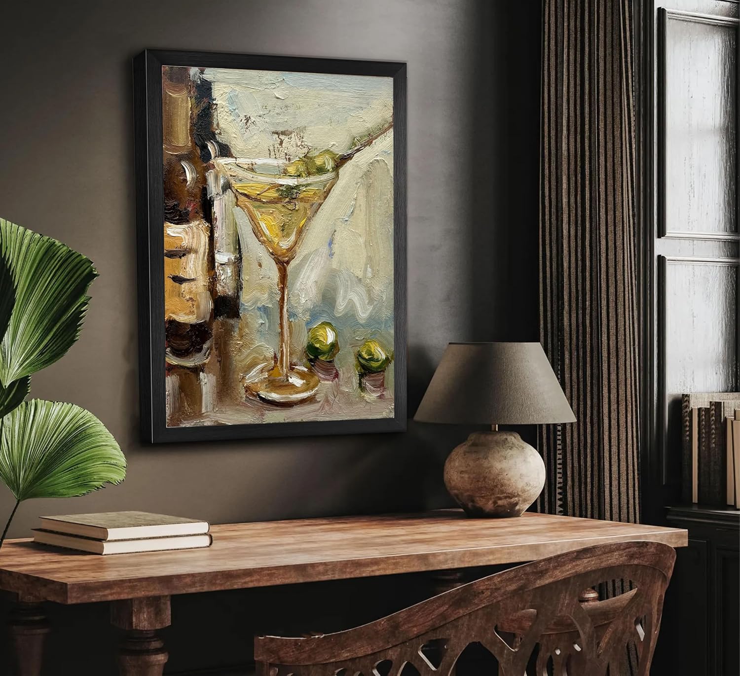 Framed painting of a cocktail on a wall above a wooden table with decor items.