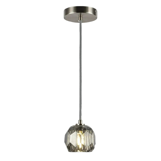 Pendant light with glass shade and metallic fixture on a gray background