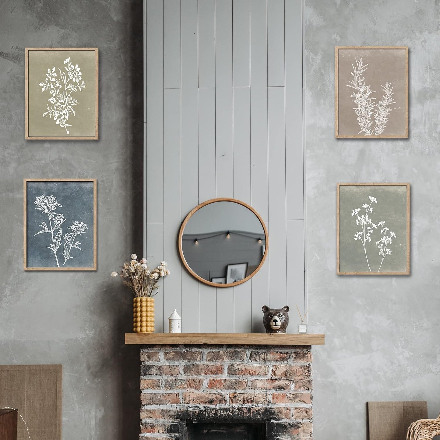 Decorative wall art above a fireplace with a round mirror and small items.