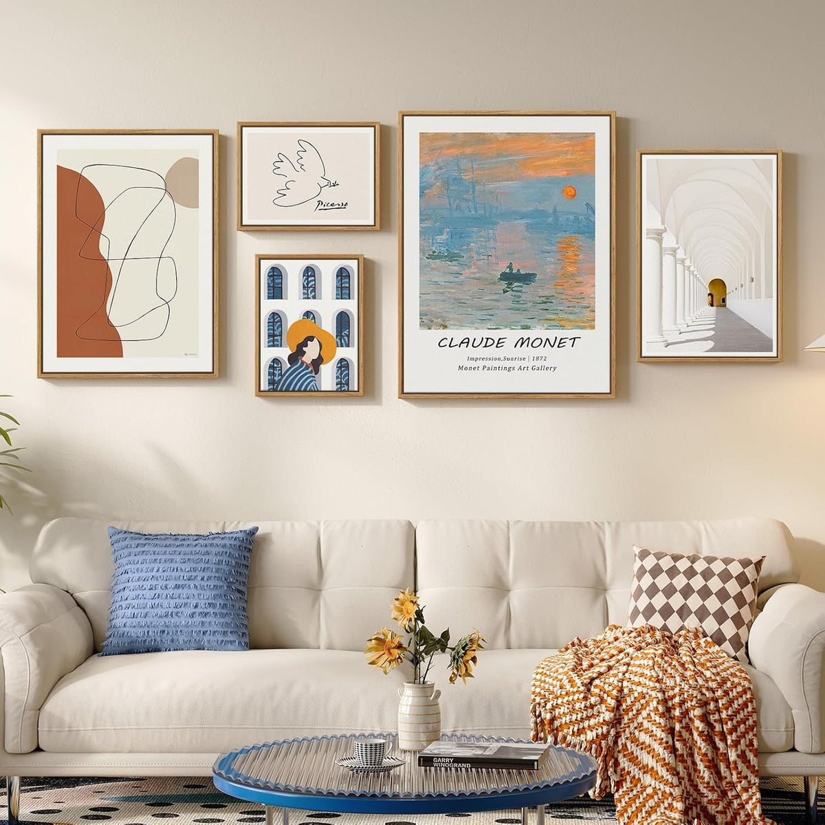 Living room with a beige sofa, decorative pillows, and framed art on the wall.
