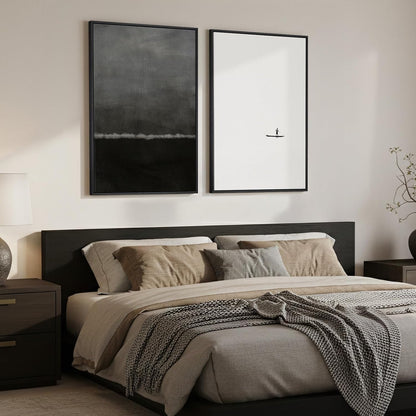 Modern bedroom with a bed, nightstands, and framed artwork on the wall.