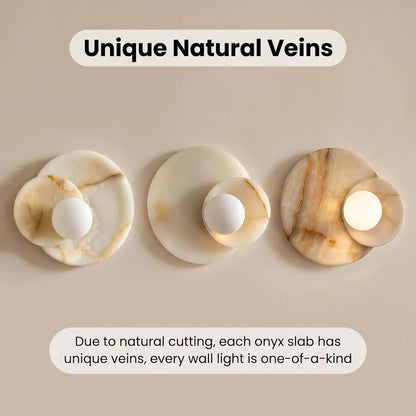 Three onyx wall lights with unique natural veins on a beige background