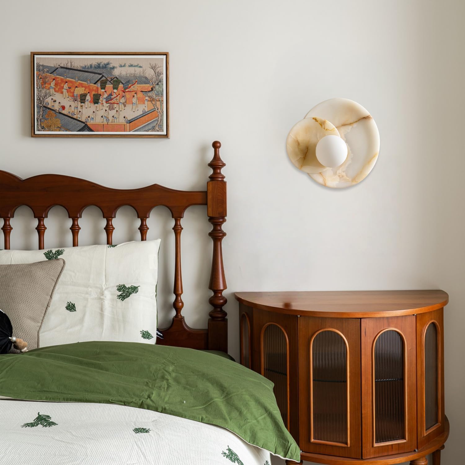 Bedroom with wooden headboard, green bedding, and round wooden side table.