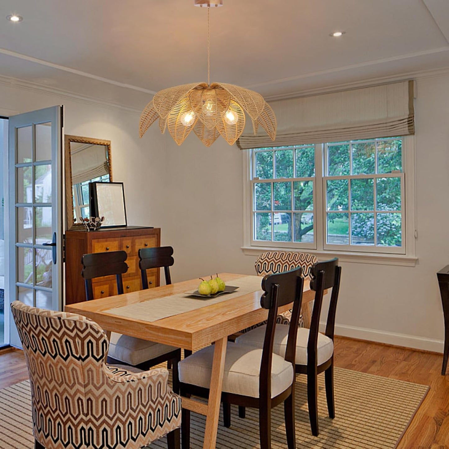 Dining room with wooden table and chairs, decorative light fixture, and window view.