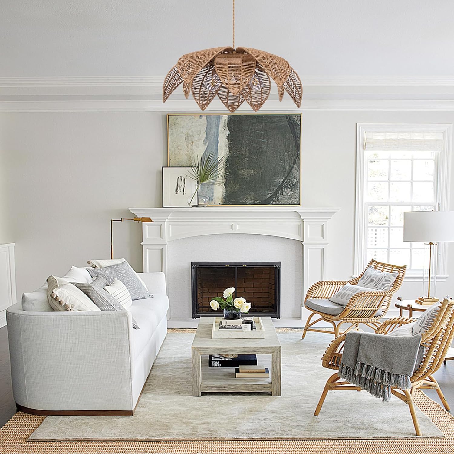 Living room with white sofa, wicker chairs, and a fireplace.