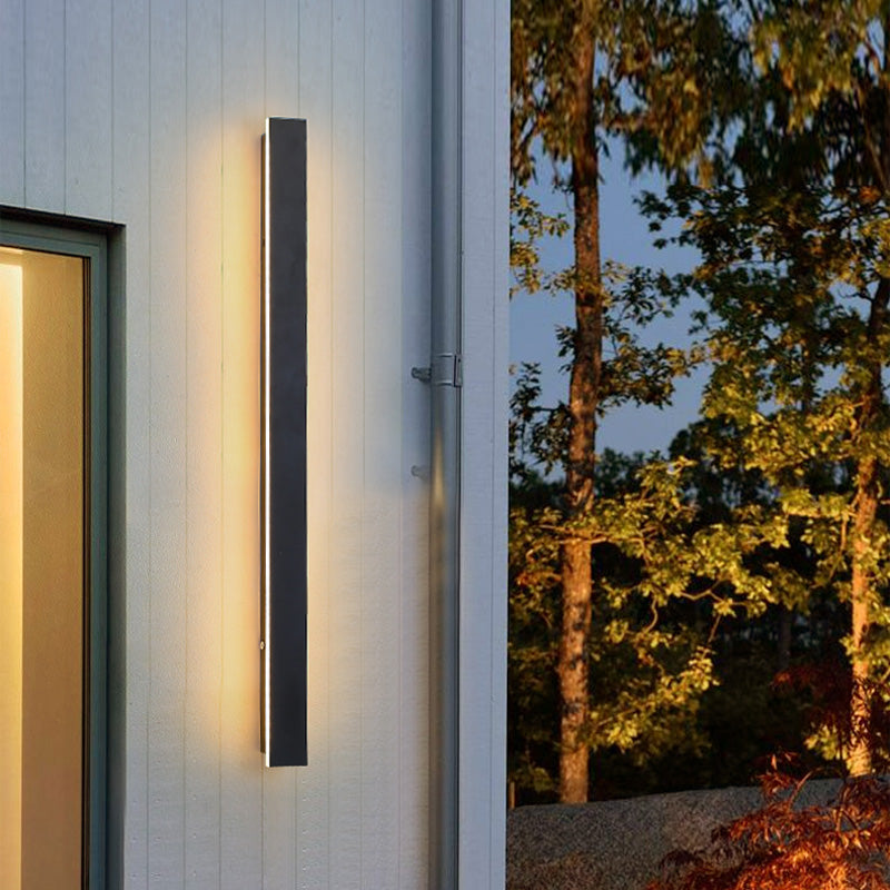 Sleek Luminex Outdoor Wall Light enhances house exterior with modern illumination.