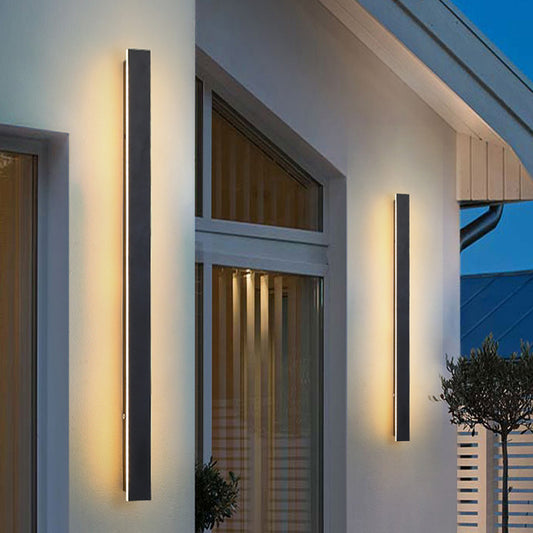 Luminex Outdoor Wall Light illuminating a modern house exterior.
