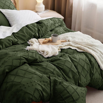 Green textured comforter on a bed with a cup of coffee and cookies.