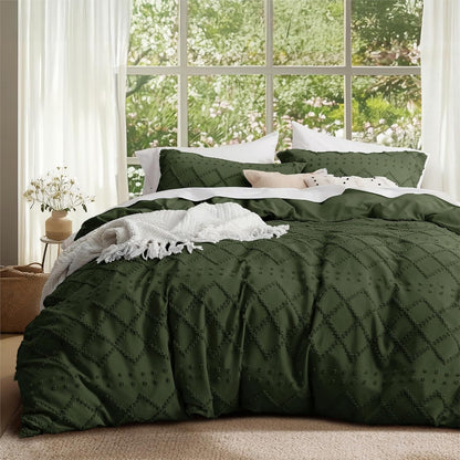 Green quilted comforter on a bed with a window view of greenery
