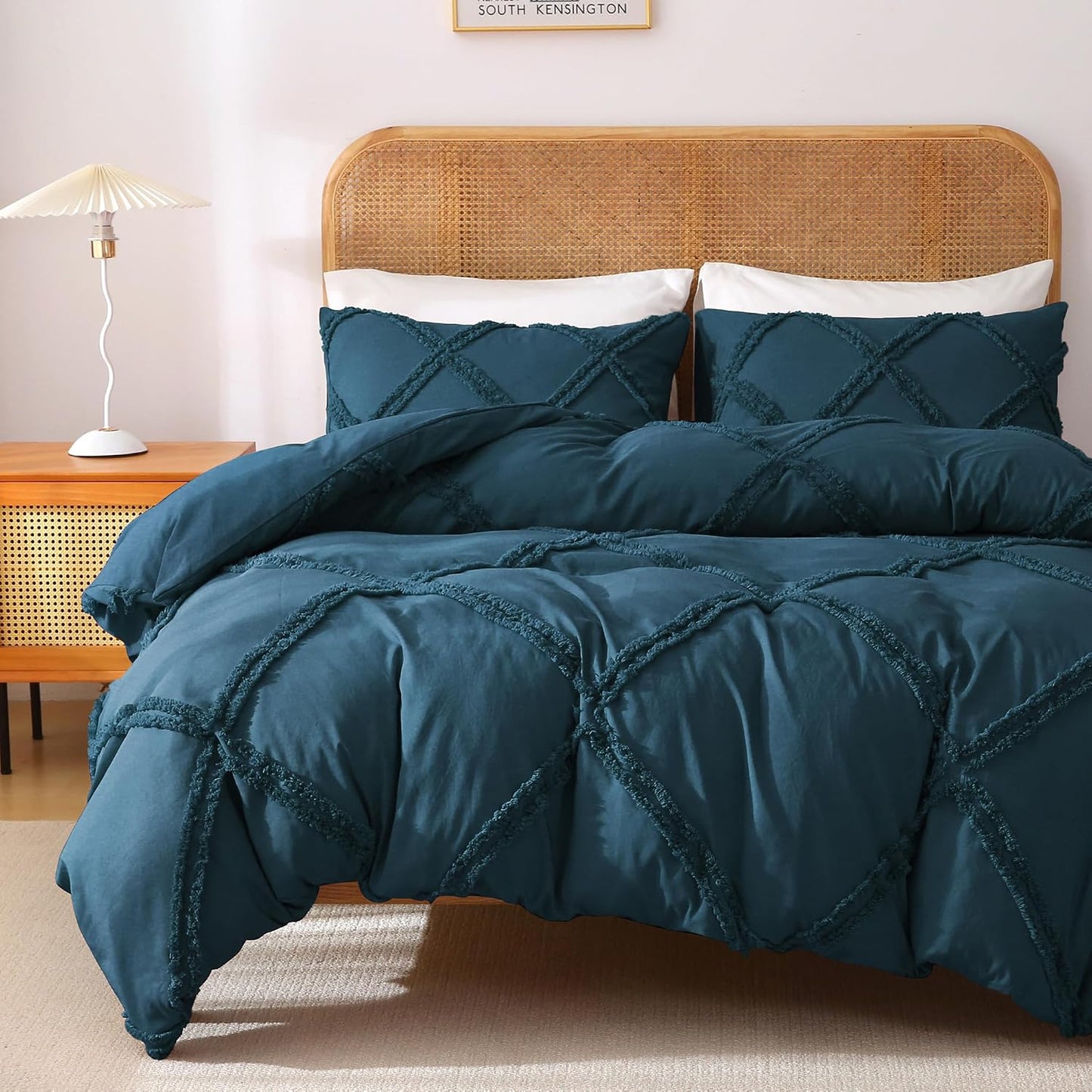 Teal textured comforter set on a bed with a wooden headboard and side table.