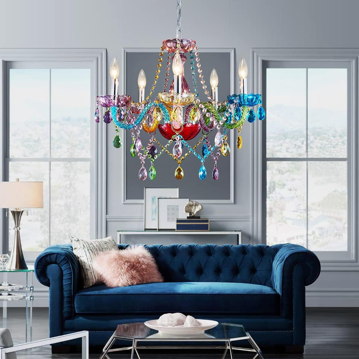 Colorful chandelier hanging above a blue sofa in a living room.