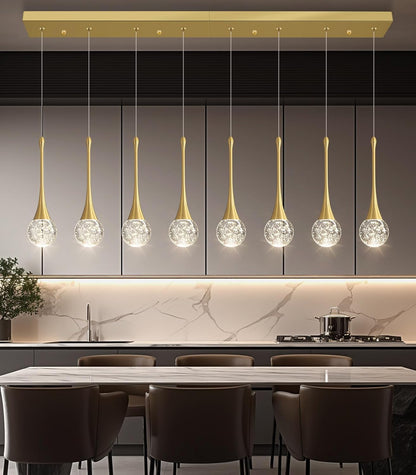 Modern kitchen with pendant lights hanging above a dining table.