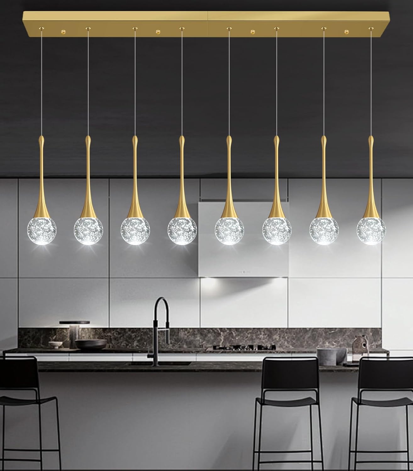 Modern kitchen with pendant lights featuring crystal balls and gold accents.