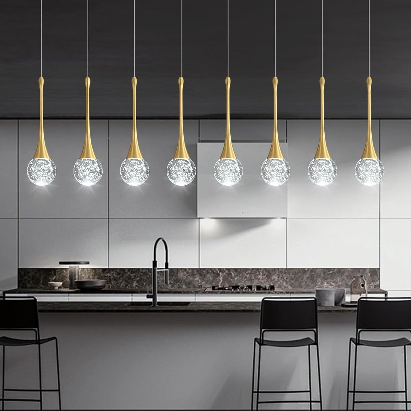Modern kitchen with pendant lights featuring crystal balls and gold accents.