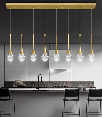 Modern kitchen with pendant lights featuring crystal balls and gold accents.