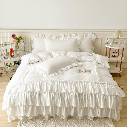 White ruffled bedding set on a bed in a bedroom setting.