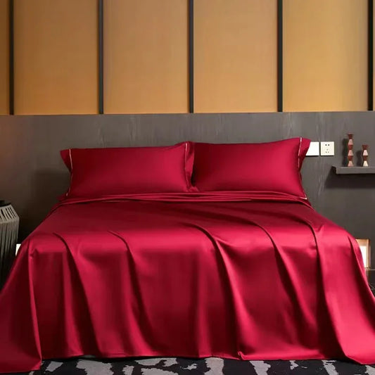 A luxurious red bed with a sleek black headboard and a matching black nightstand. LuxeSatin Summer Bed Sheet Set.