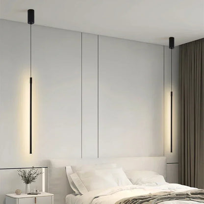 Modern bedroom with white walls and a bed, illuminated by a GlowTech LED Pendant Light.