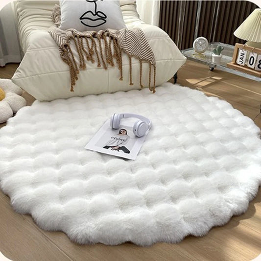 A round rug with fluffy white fur, resembling a snowy soft faux rabbit rug.