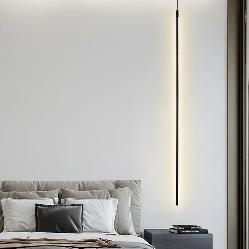 Contemporary bedroom with a white decor and a bed, illuminated by a GlowTech LED Pendant Light.