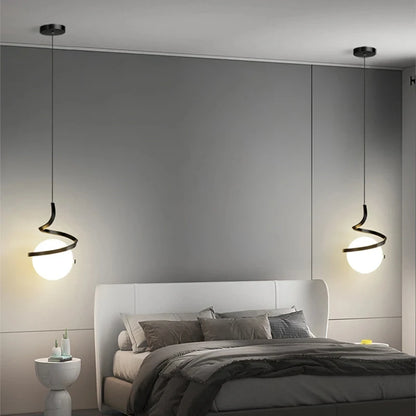 Modern pendant lights illuminating a bedroom with a contemporary design.