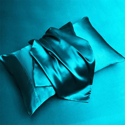 LuxeSatin Summer Bed Sheet Set featuring a bed adorned with a blue satin sheet.