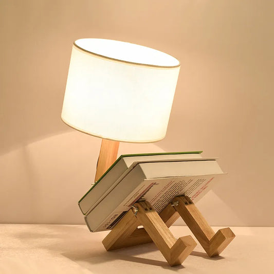 Wooden lamp with book on top, perfect for reading.
