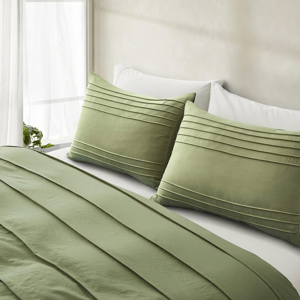 Green pillowcases with envelope closure on a bed in a bright room.