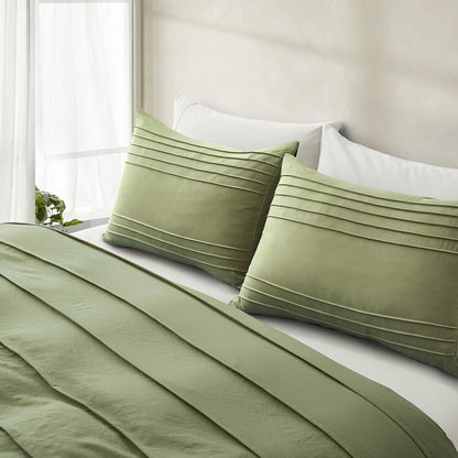 Green pillowcases with envelope closure on a bed in a bright room.