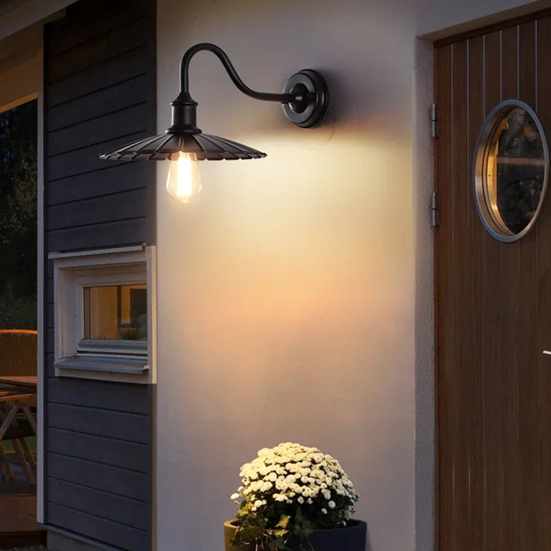 Charming Americana Loft Wall Lantern: Black outdoor wall light featuring an antique bulb.