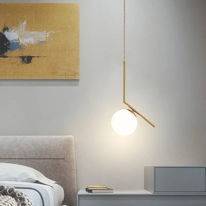 Sleek pendant light adds modern touch to minimalist bedroom.