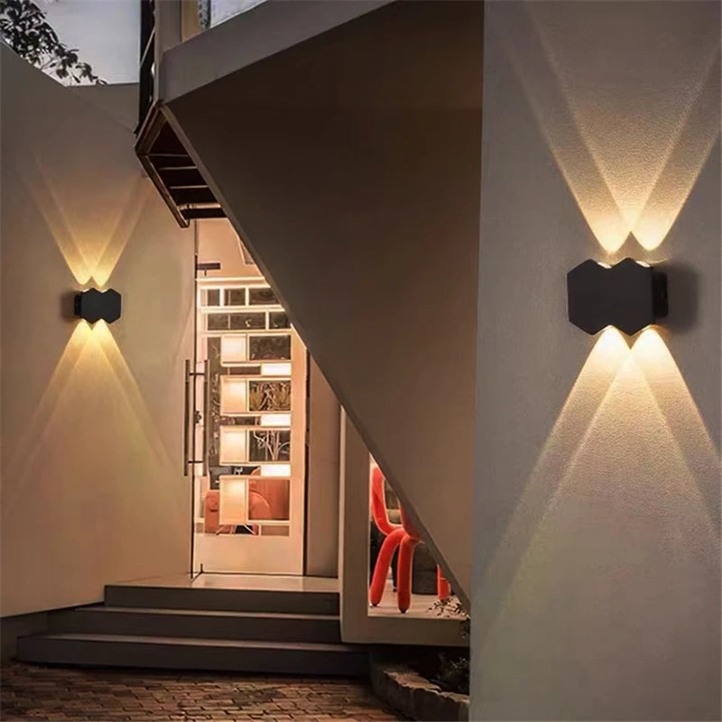 Double lights brightly illuminate the outdoor wall, courtesy of the Trilight Glow LED Wall Sconce.