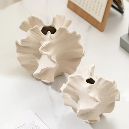 Side view of beige matte ceramic coral vase showing sculptural rippled edges