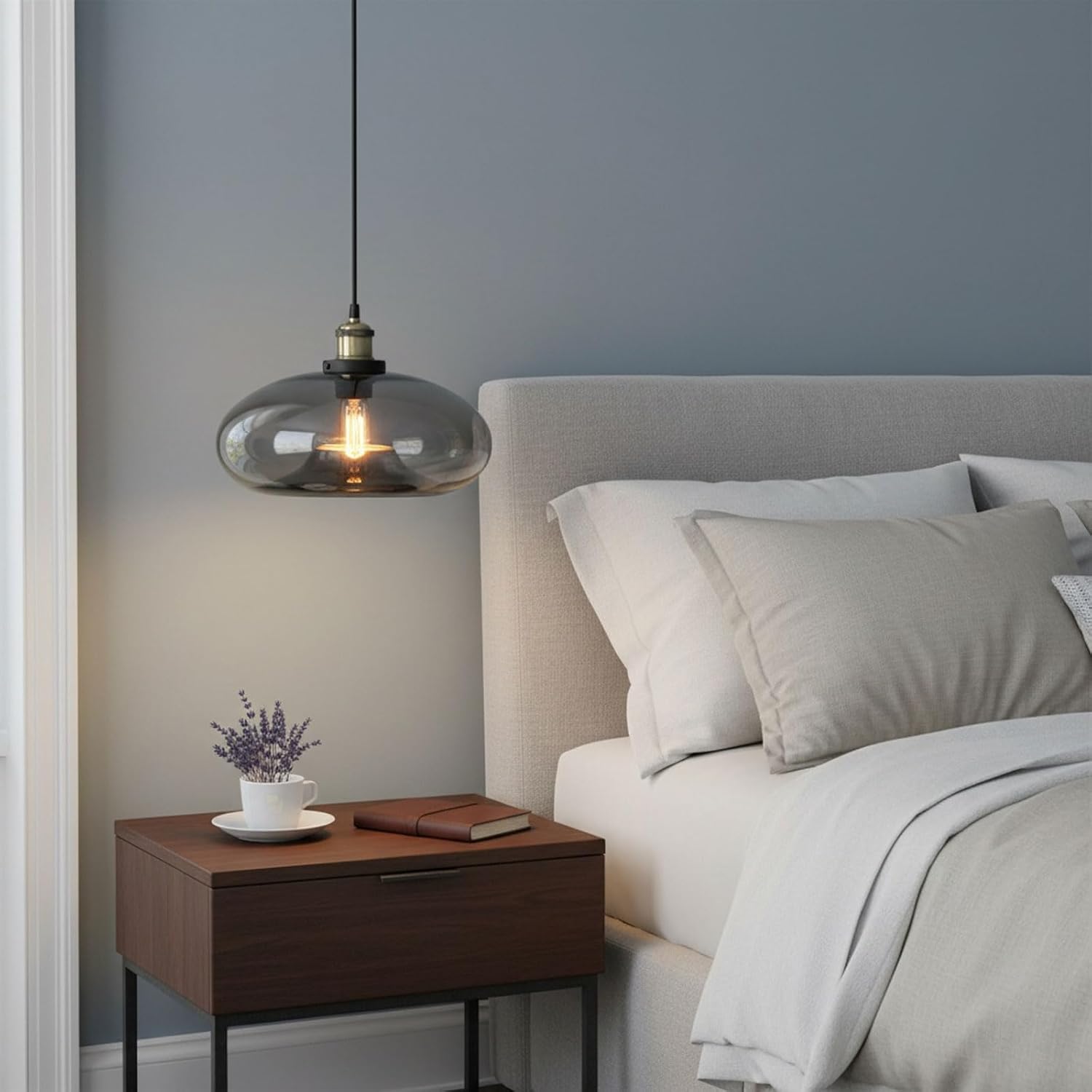 Modern bedroom with a bed, nightstand, and pendant light.