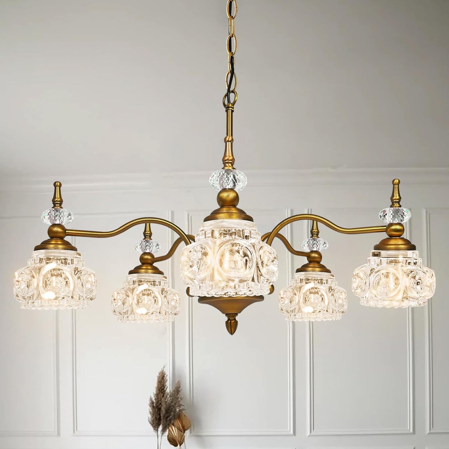 Vintage-style chandelier with crystal glass shades on a neutral background
