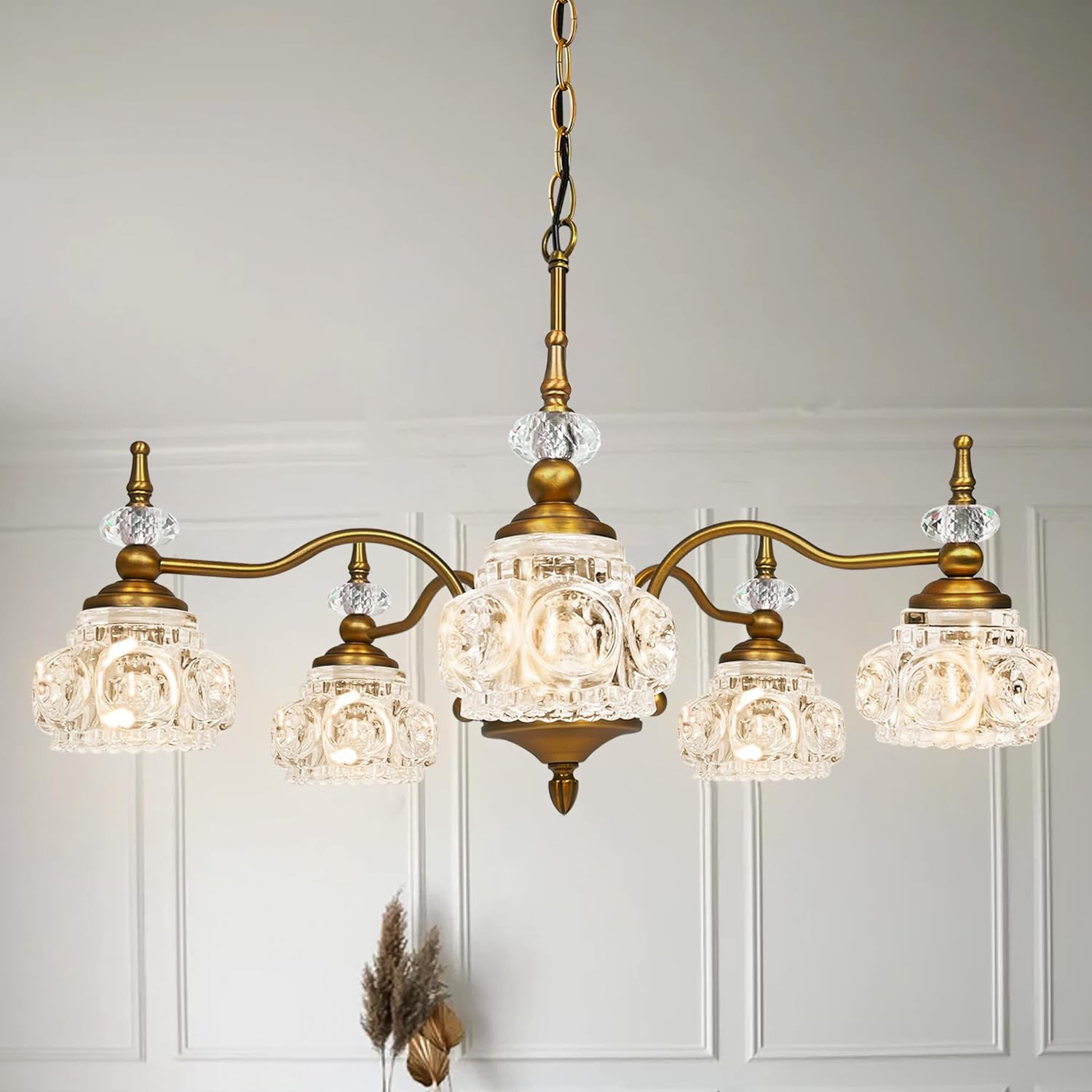 Vintage-style chandelier with crystal glass shades on a neutral background