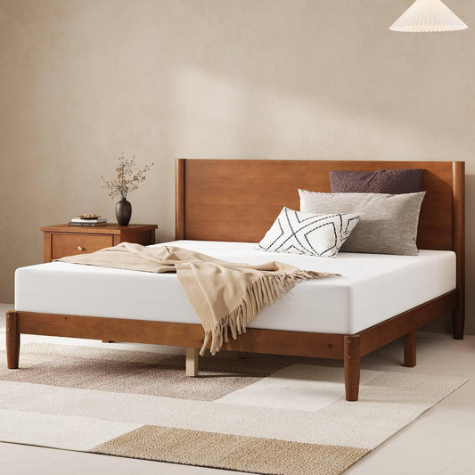 Wooden bed with white bedding and decorative pillows in a bedroom setting.