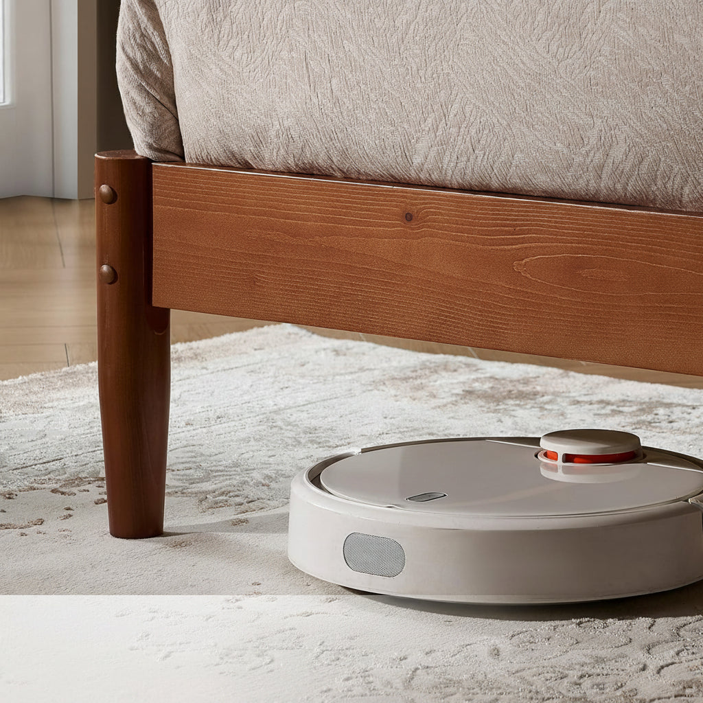 Robotic vacuum cleaner under a bed with text highlighting its ability to clean under beds.