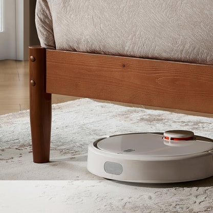 Robotic vacuum cleaner under a bed with text highlighting its ability to clean under beds.