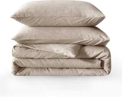 Folded beige bedding set with two pillows on a white background