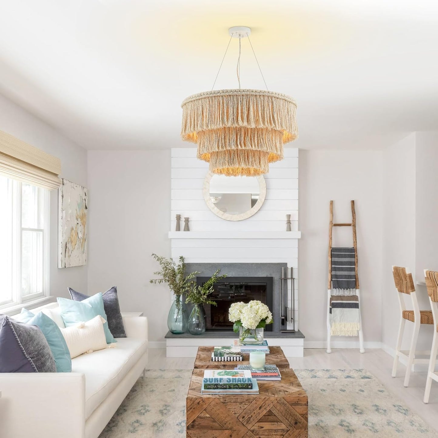 Modern living room with a chandelier, sofa, coffee table, and decorative items.